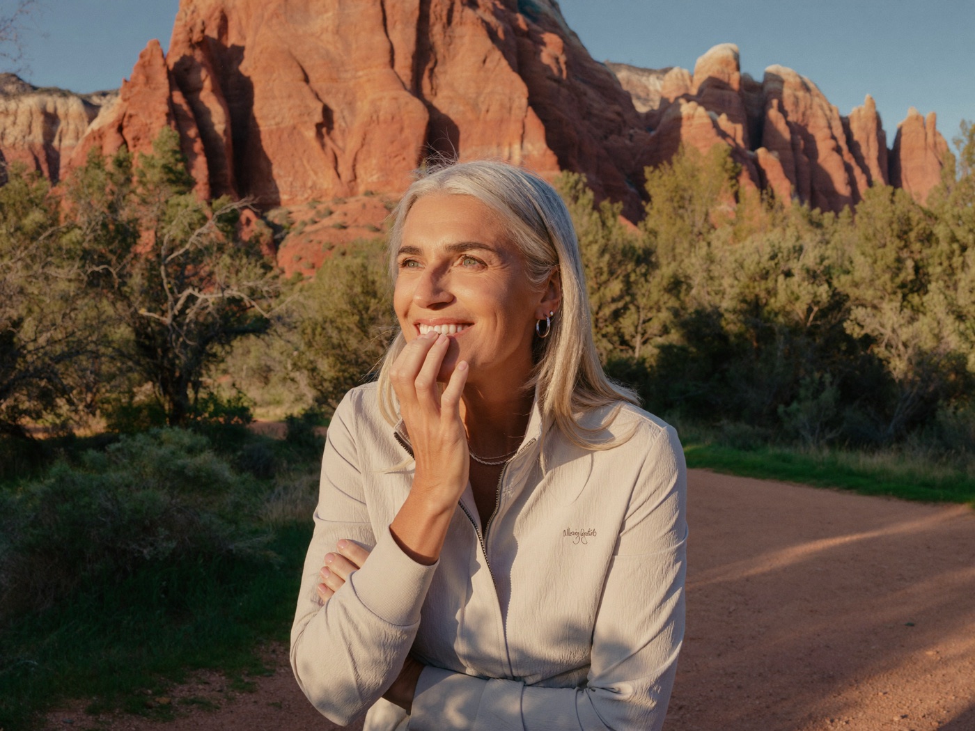A woman in her early sixties hiking a red-rock trail in southern Utah